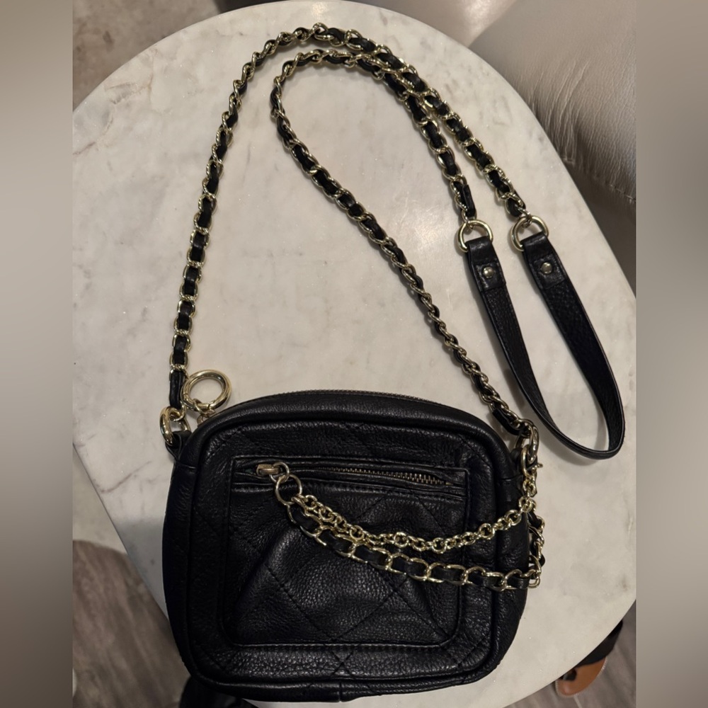 Betsey Johnson small black leather bag with gold chain detail.